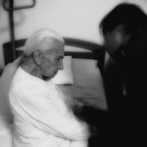 Pharmacist conducting a structured medication review with a frail elderly female care home patient